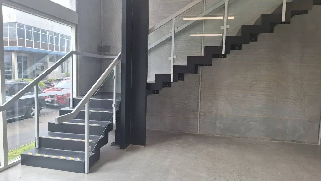 Modern staircase in a commercial space built by Builders Rodney showcasing builders rodney expertise.