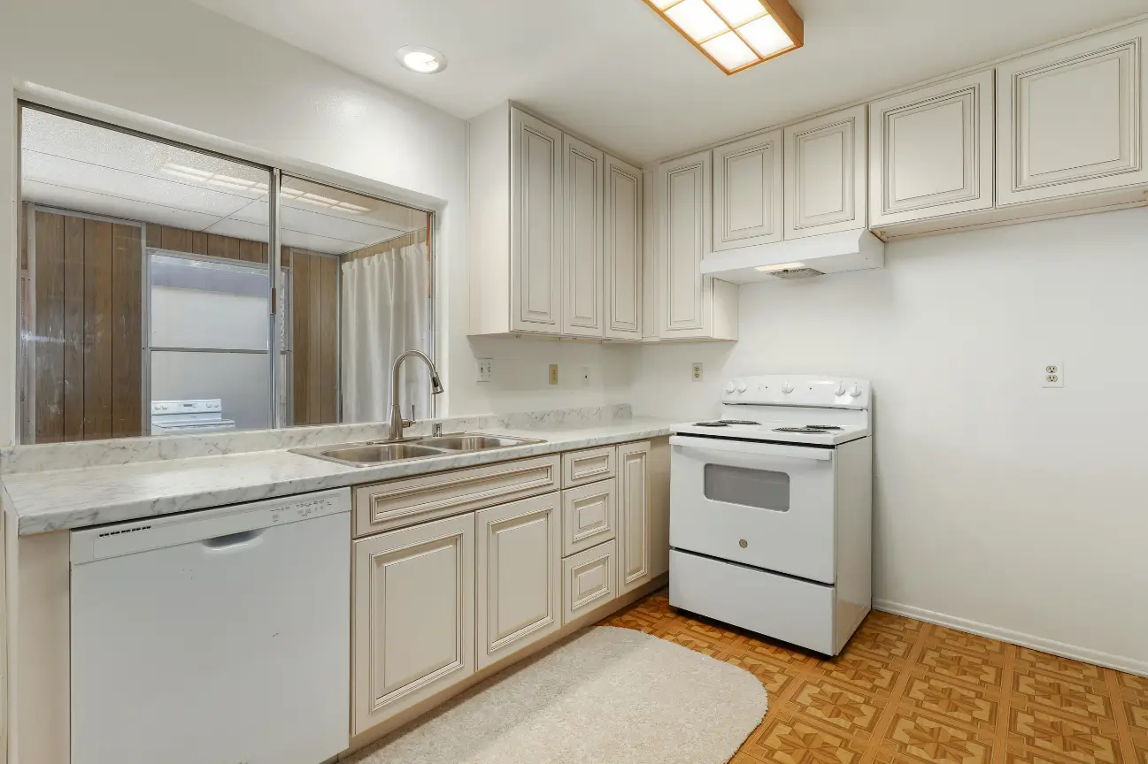 Clean and bright kitchen with traditional cabinetry renovated by Builders Rodney kitchen renovations experts