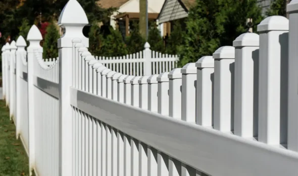 A beautifully crafted white fence designed and installed by fencing contractors from Builders Rodney.
