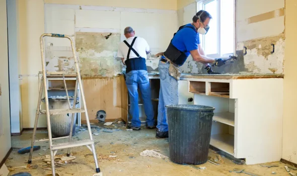 Builders Rodney team removing old cabinets during kitchen renovations process